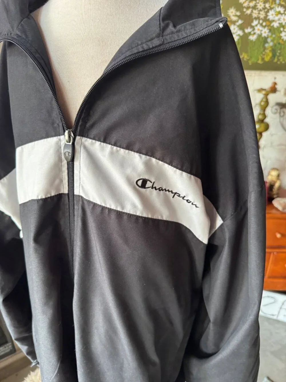 vintage Champion windbreaker jacket featuring a black body with a white chest st